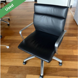 Used black vinyl adjustable office chair with wheels and armrests